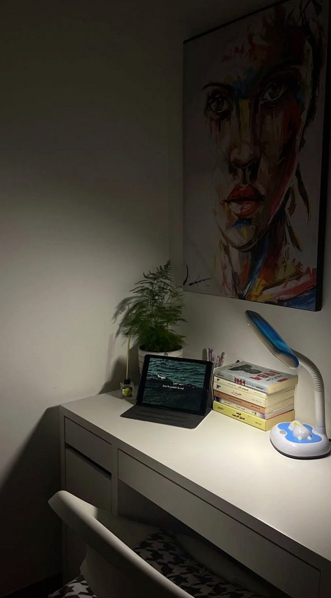 暗い部屋で卓上ライトが照らす机の上